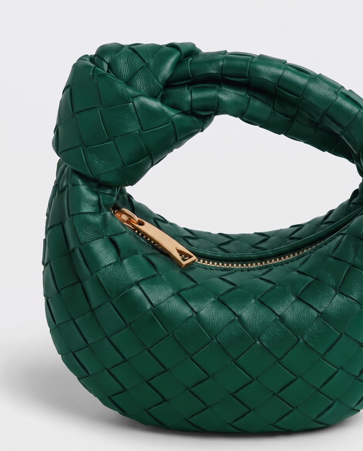 Knot Mini woven leather bag in Emerald – close-up of the knotted handle