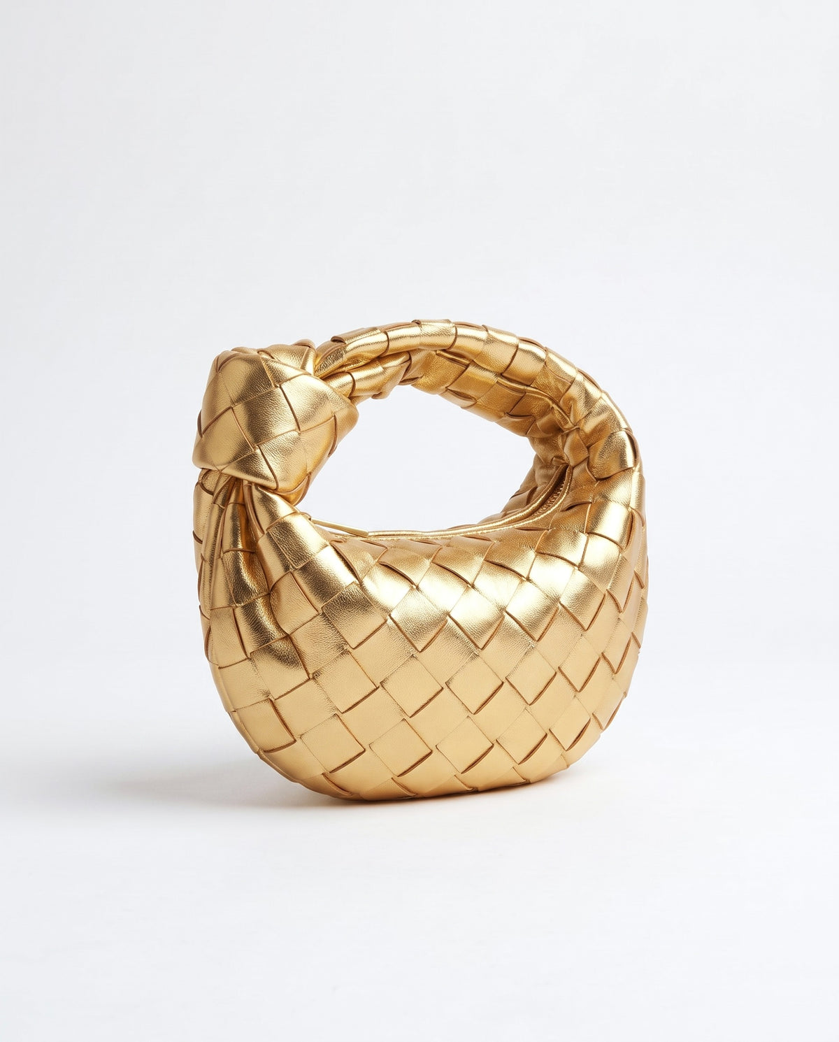 Knot Mini woven leather bag in Gold – three-quarter view