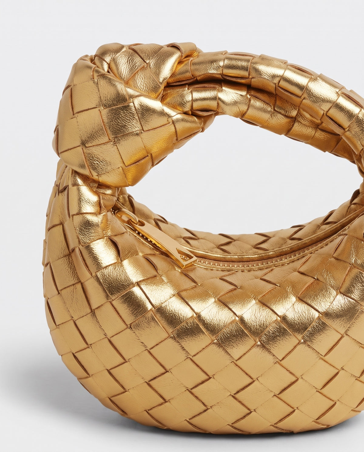 Knot Mini woven leather bag in Gold – close-up of the knotted handle