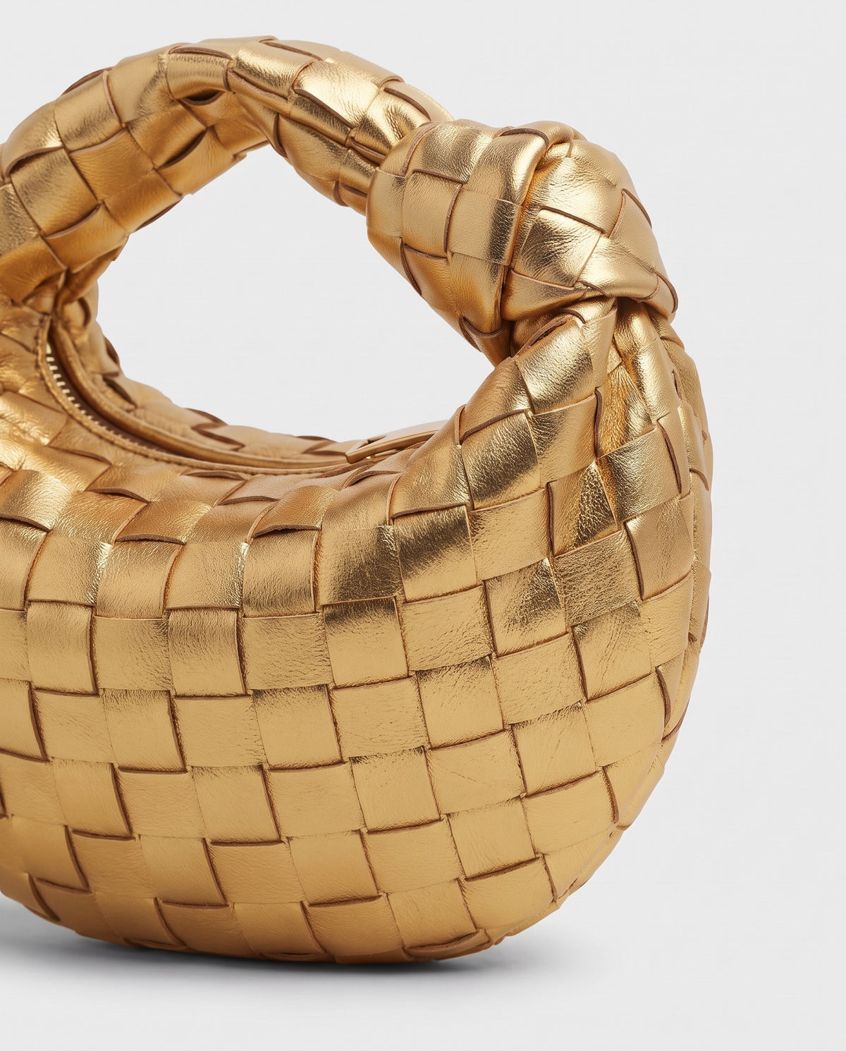 Knot Mini woven leather bag in Gold – close-up of the woven leather
