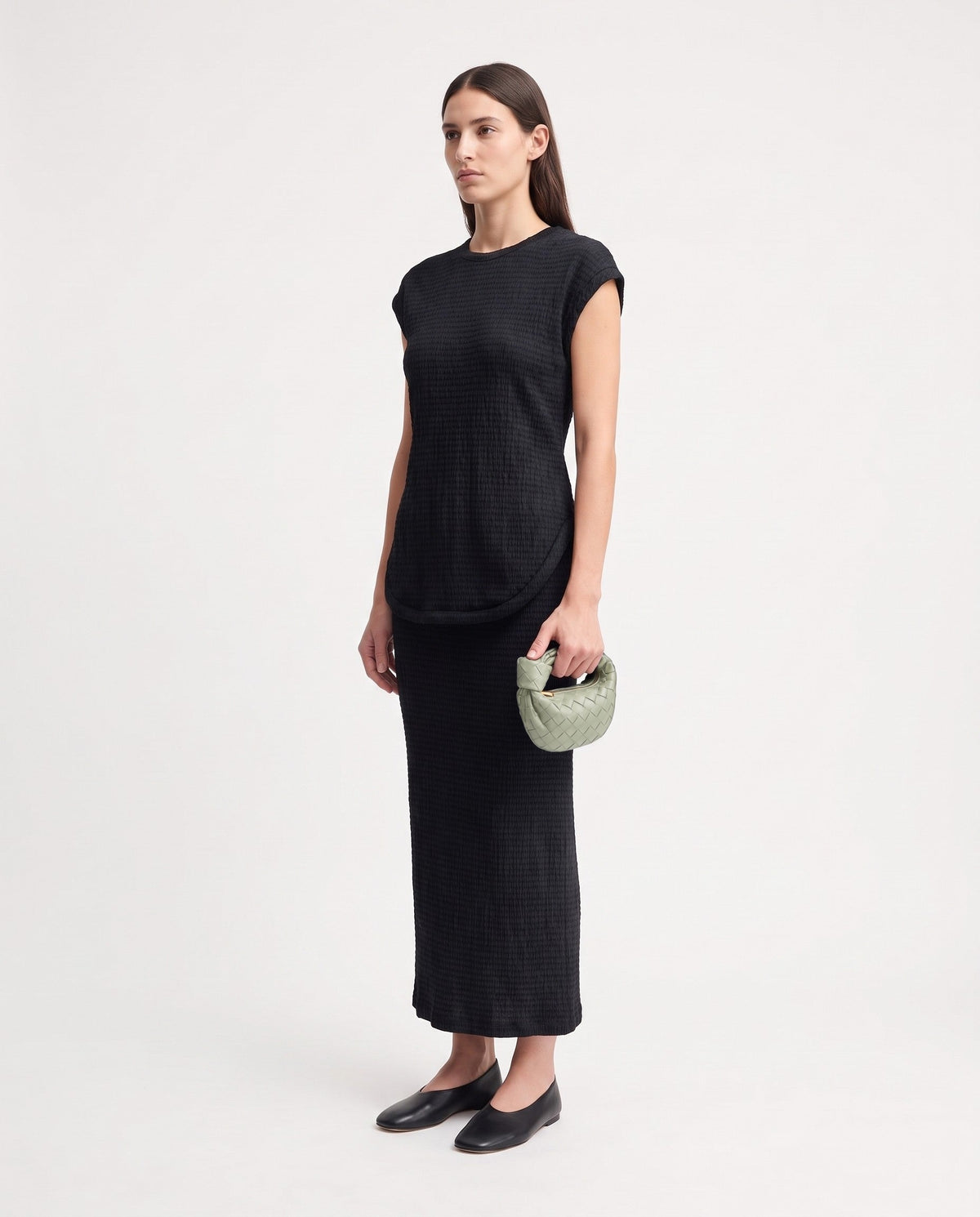 Knot Mini woven leather bag in Pistachio – model holding it, full length