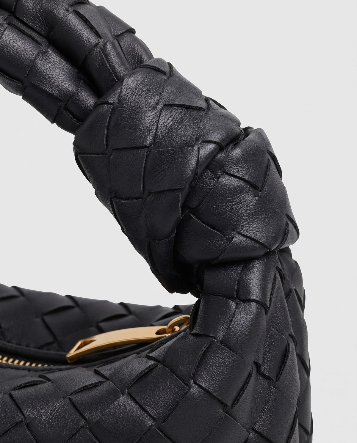 Knot Small woven leather bag in Black – close-up of the knotted handle