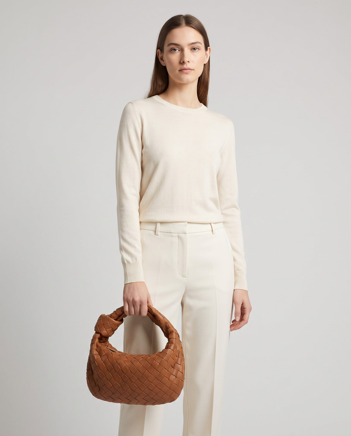 Knot Small woven leather bag in Brown – model holding it, full length
