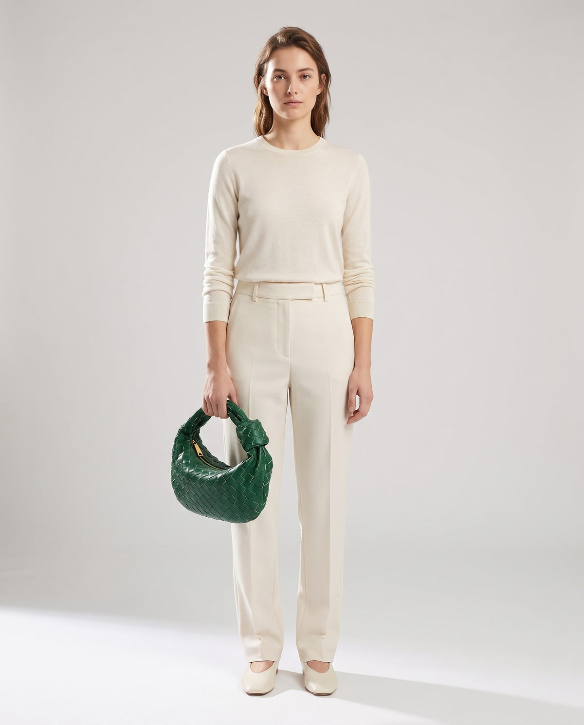 Knot Small woven leather bag in Green – model holding it, full length