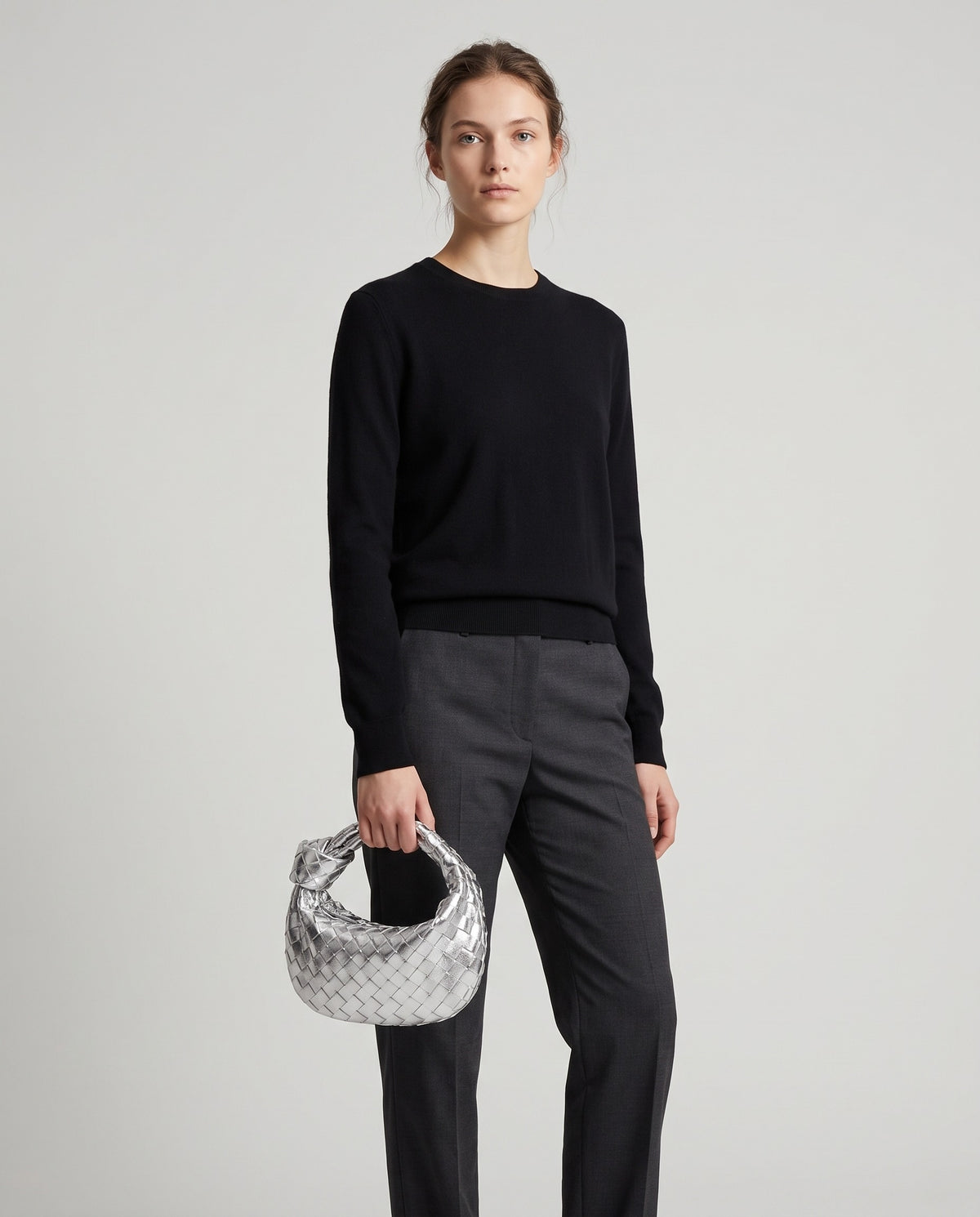 Knot Small woven leather bag in Silver – model holding it, full length
