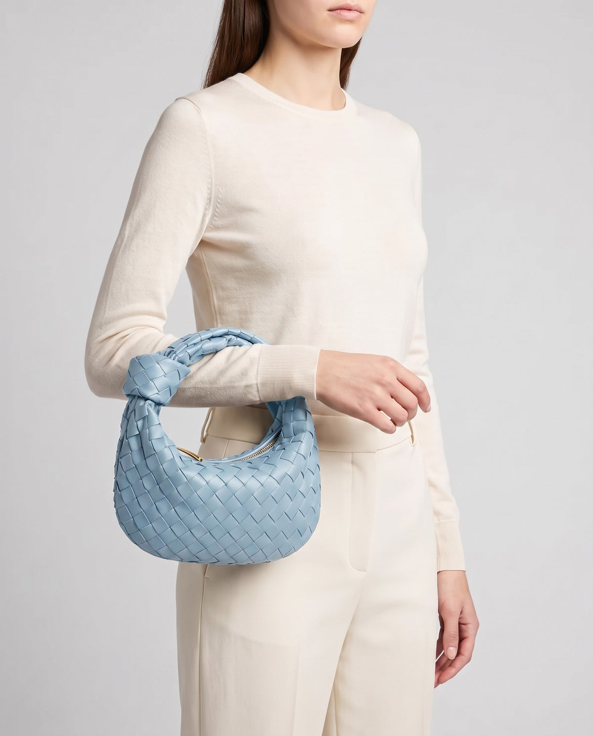 Knot Small woven leather bag in Sky Blue – model carrying it