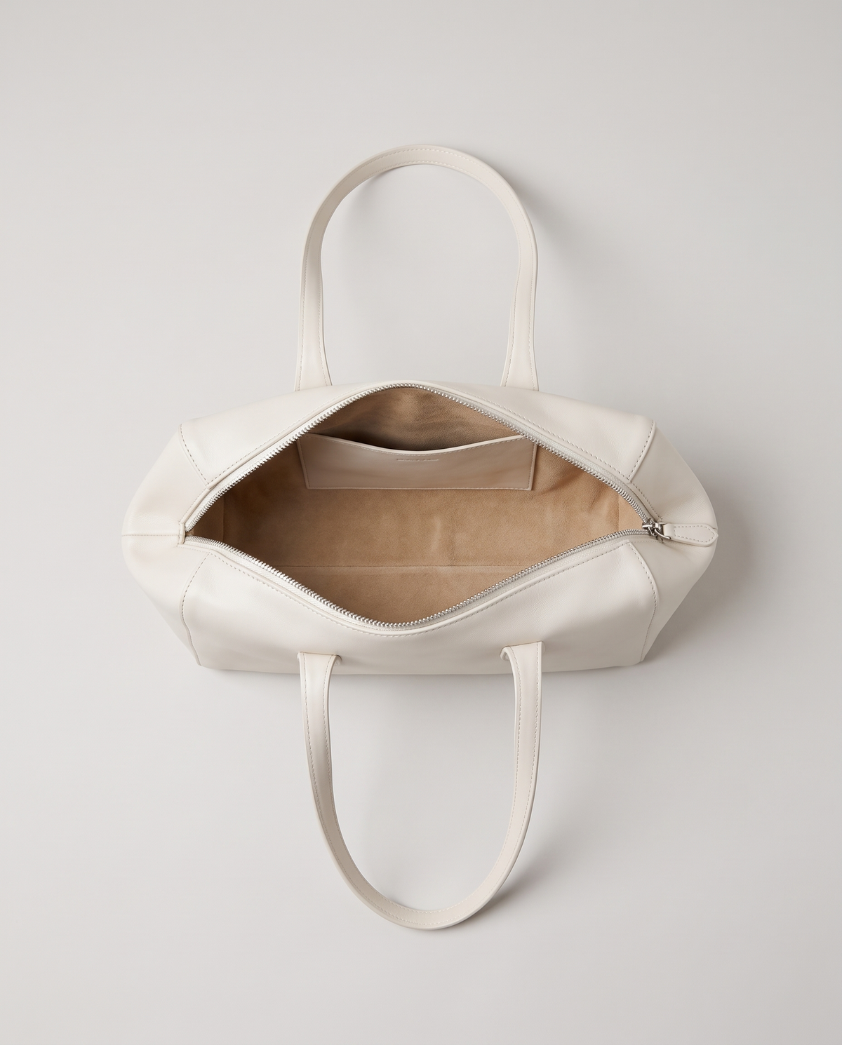 Lira leather shoulder bag in White – view from above with the zip open