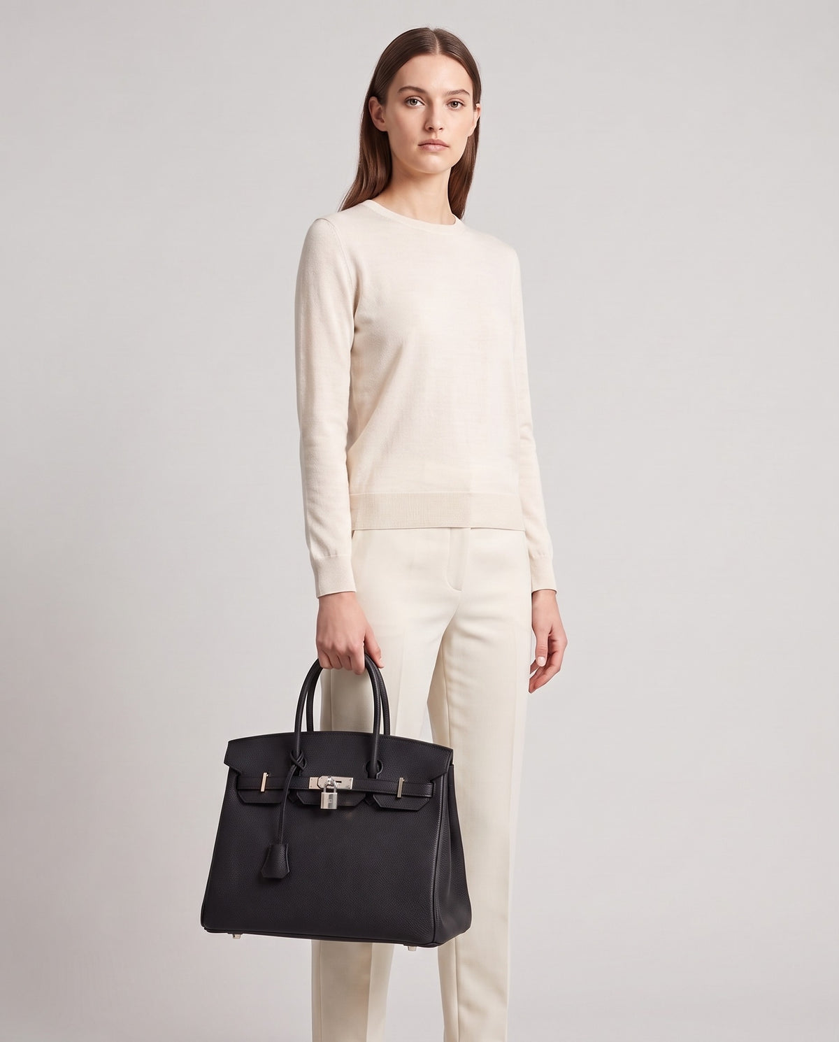 Lock Large leather top-handle bag in Onyx – model holding it, full length