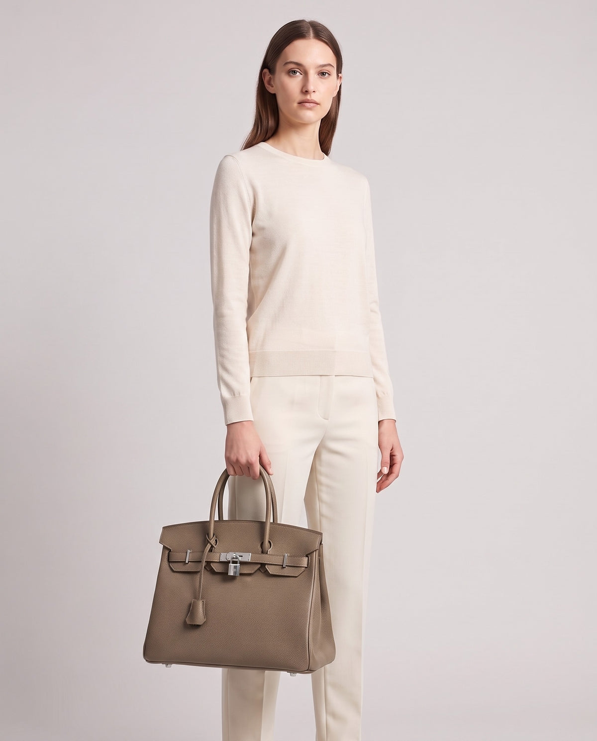 Lock Large leather top-handle bag in Taupe – model holding it, full length