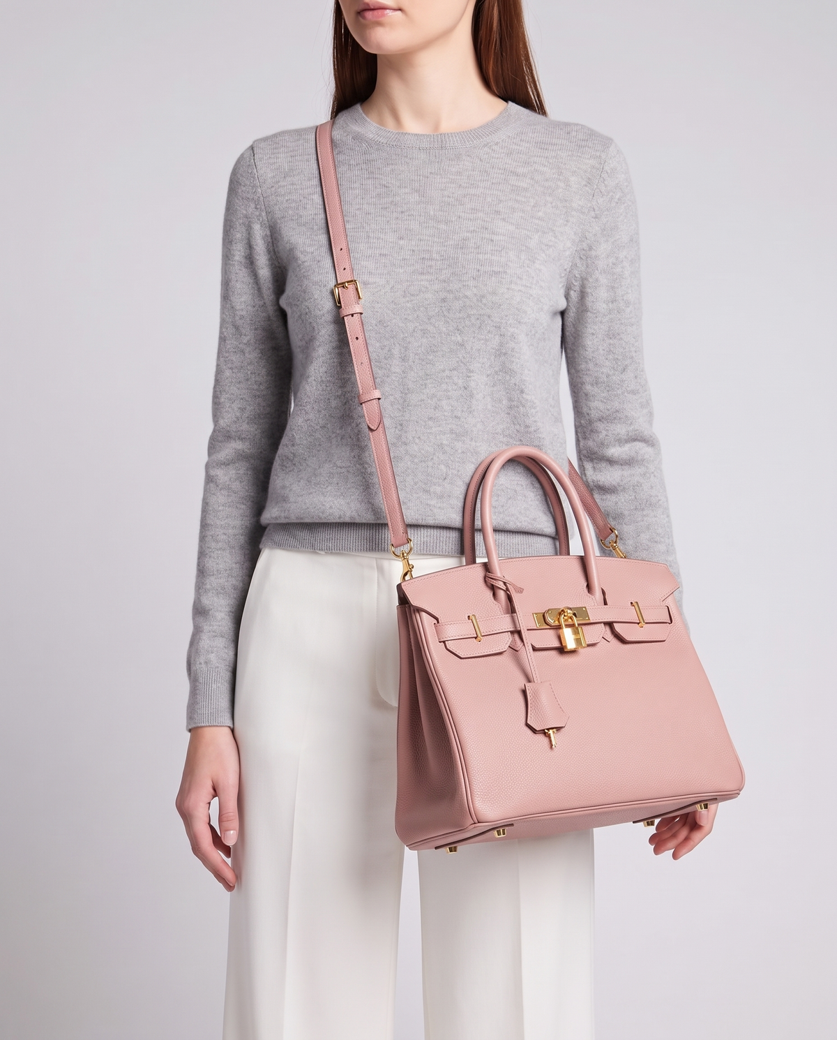 Lock Medium leather top-handle bag in Blush – model wearing it crossbody on the detachable shoulder strap
