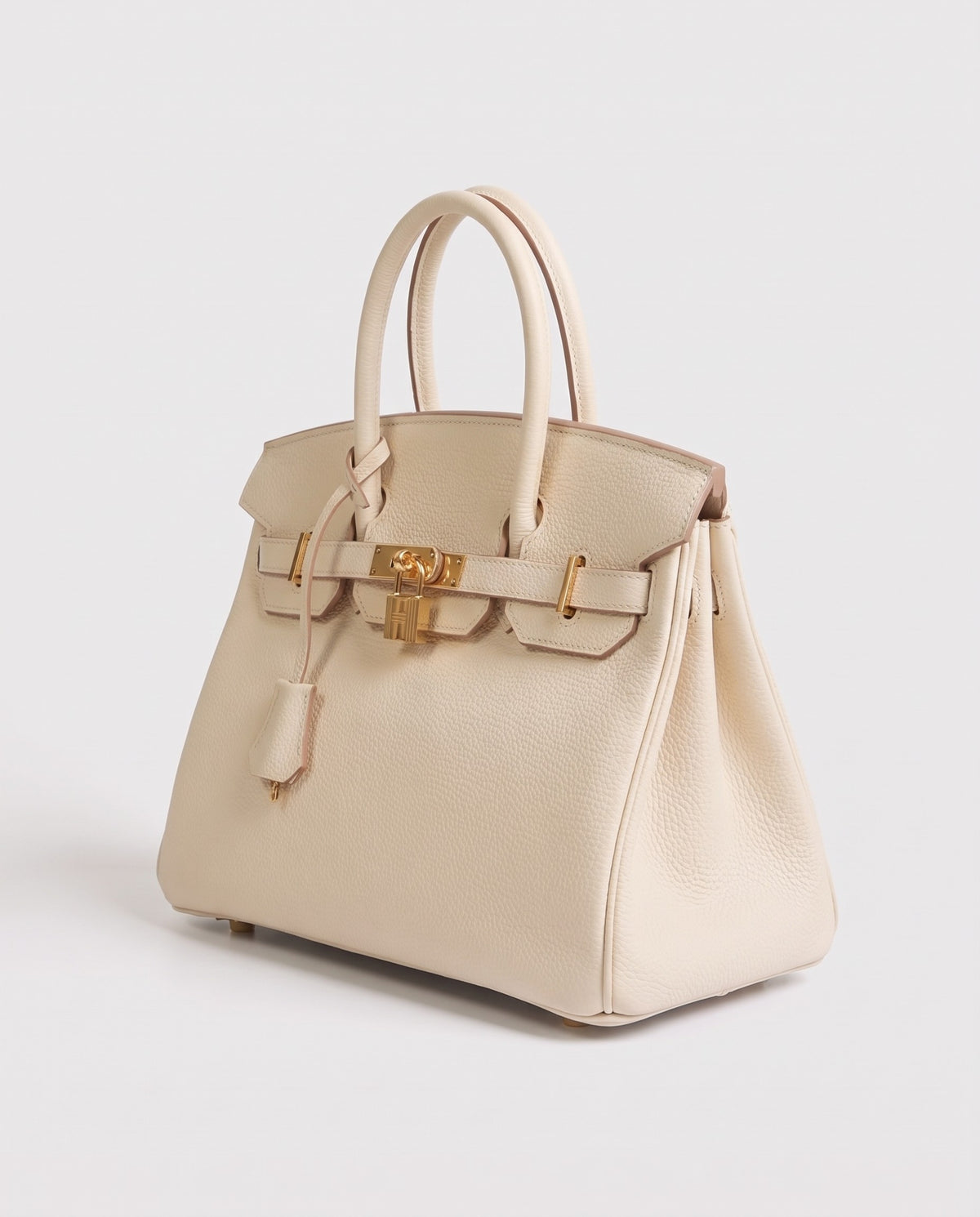 Lock Medium leather top-handle bag in Cream – three-quarter view