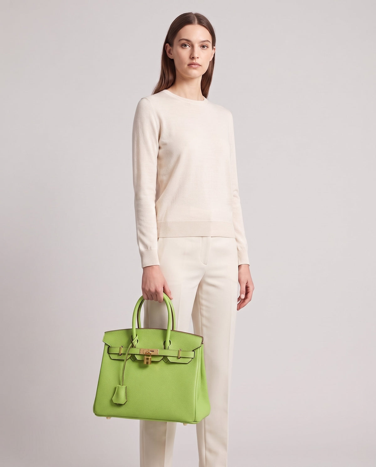 Lock Small leather top-handle bag in Avocado – model holding it, full length