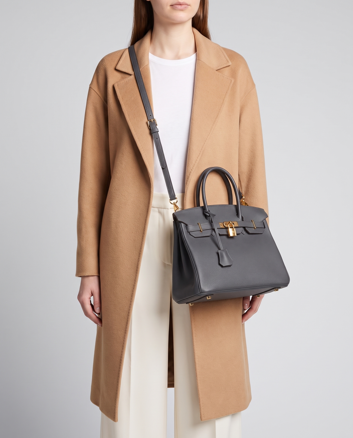 Lock Small leather top-handle bag in Charcoal – model wearing it crossbody on the detachable shoulder strap