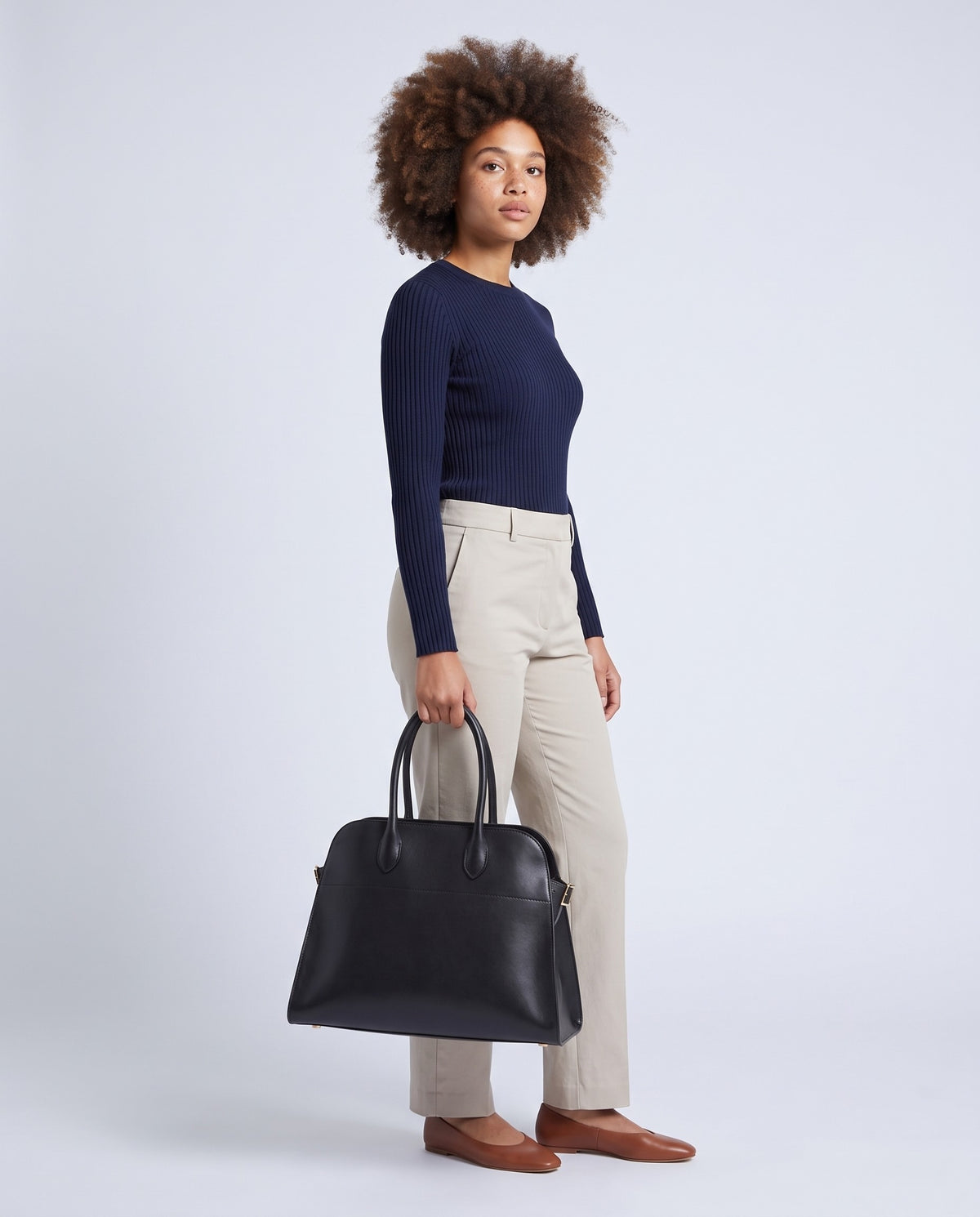 Model carrying the Milano Large bag in Black leather – full length
