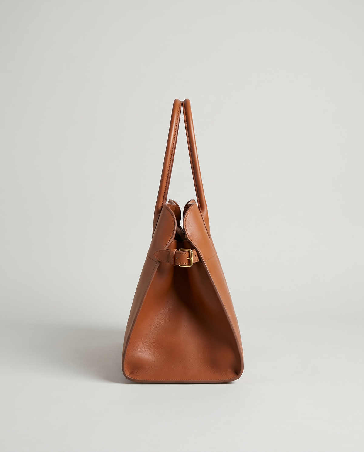 Milano Small top-handle bag in Brown – side view showing the buckled side strap