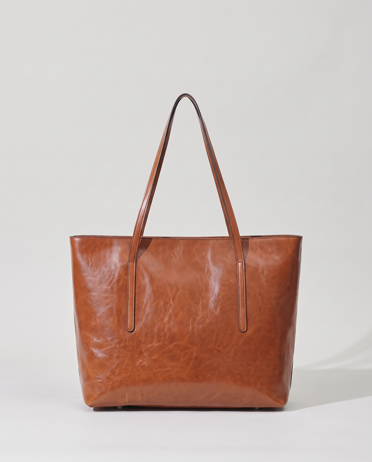 Molo oil-waxed leather tote in cognac, back view