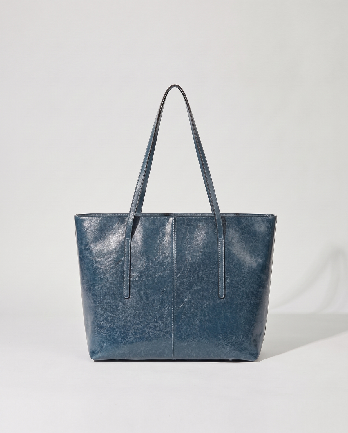 Molo oil-waxed leather tote in denim, back view