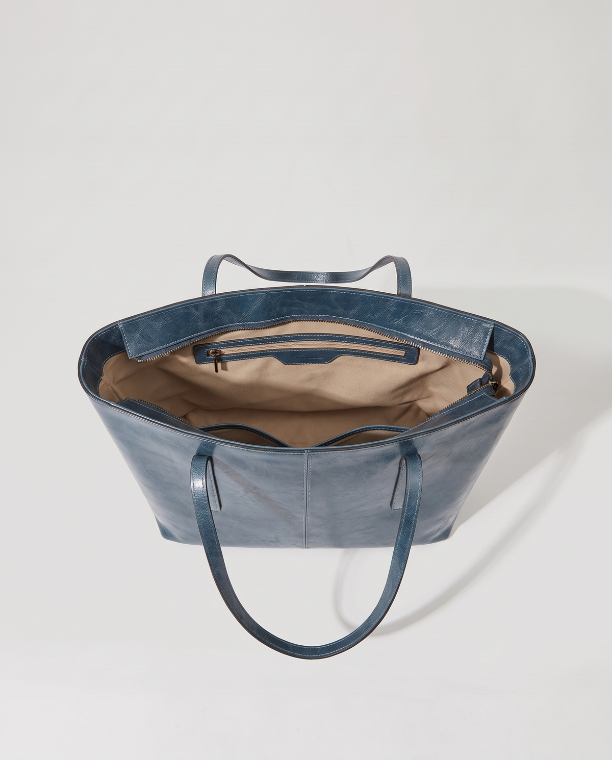 Molo oil-waxed leather tote in denim, open showing interior