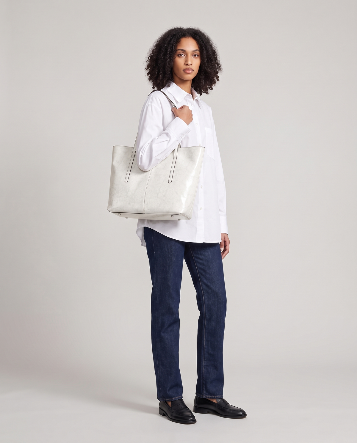 Model with the Molo oil-waxed leather tote in white, full length