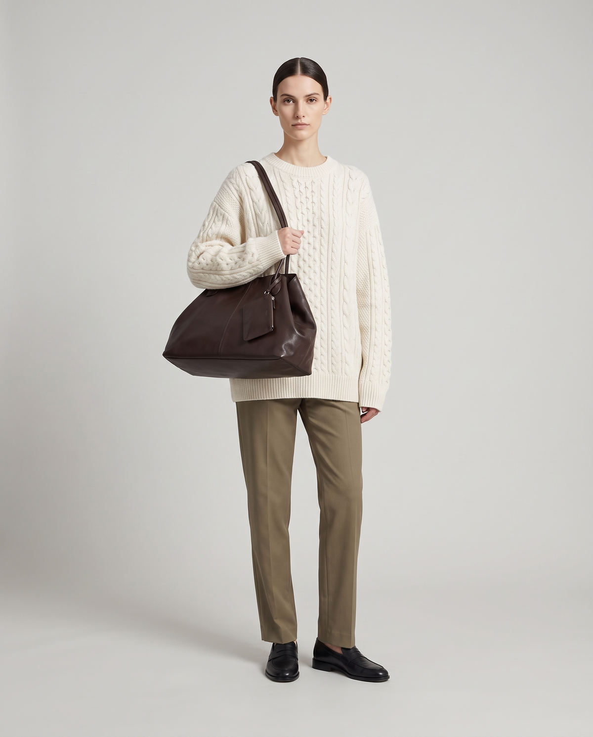 Nido leather tote in Chocolate – model wearing it on her shoulder, full length