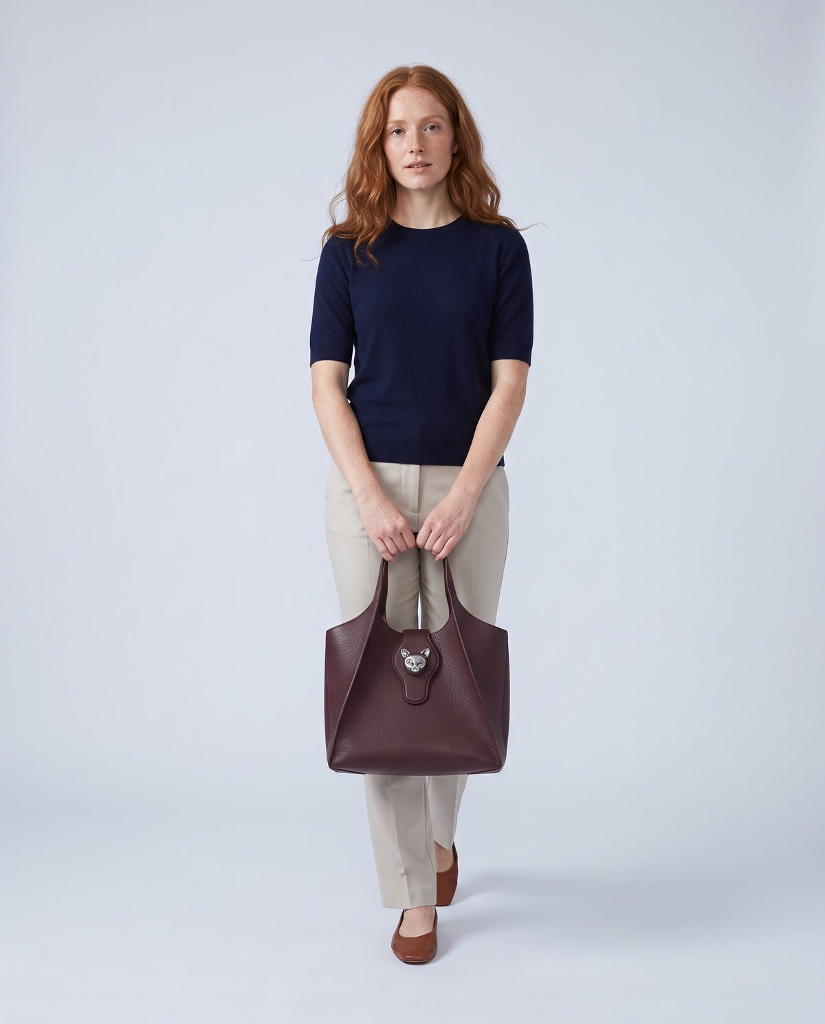 Model carrying the Onda leather tote in Burgundy – full length