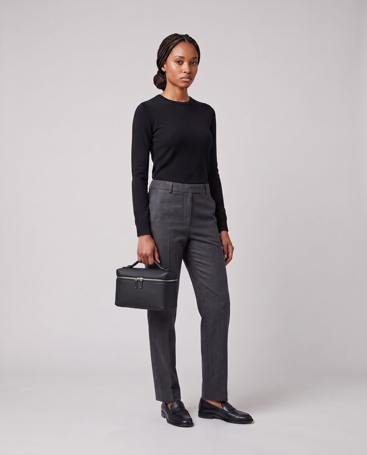 Model holding the Valentina Orvieto Small top-handle bag in Black leather, full length