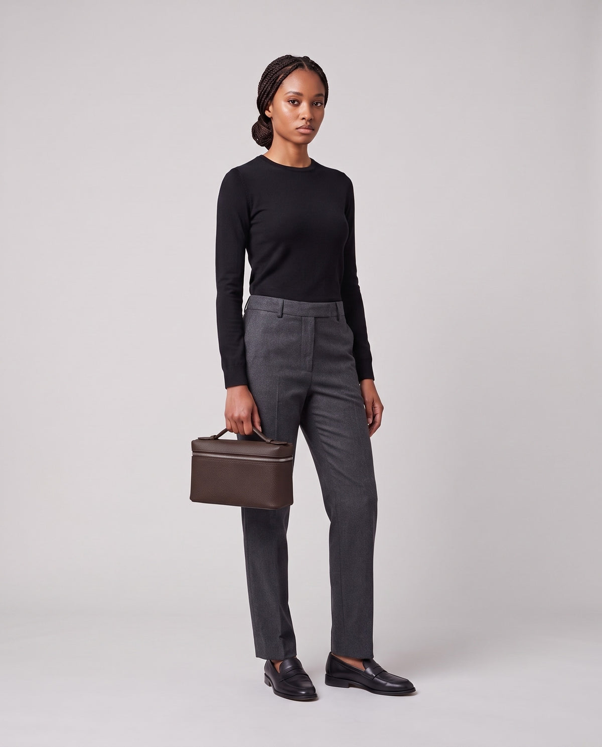 Model holding the Valentina Orvieto Small top-handle bag in Chocolate leather, full length