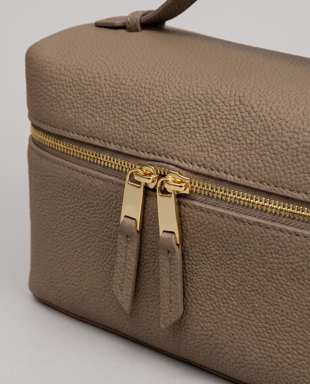 Gold zip detail on the Orvieto vanity case in Taupe