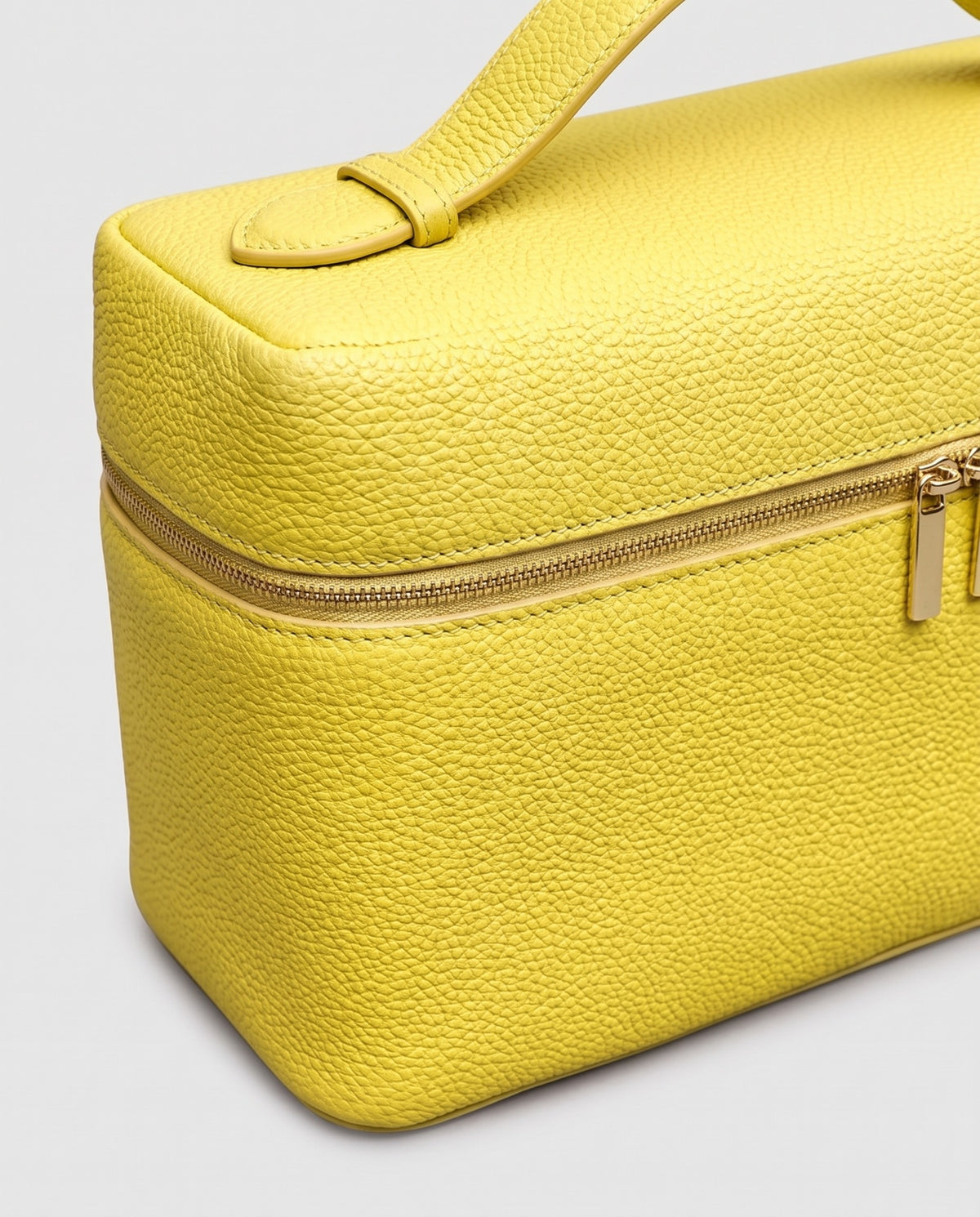 Close-up of the pebbled cowhide leather on the Orvieto vanity case in Yellow