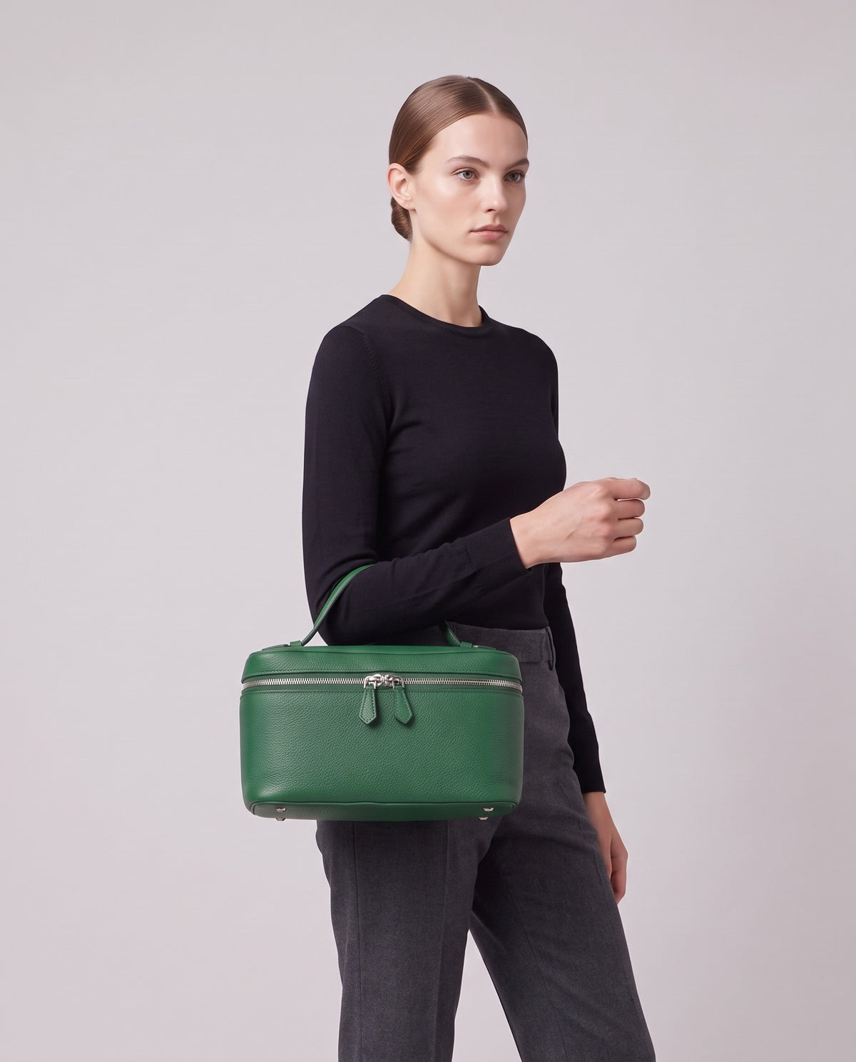 Model carrying the Orvieto vanity case in Green