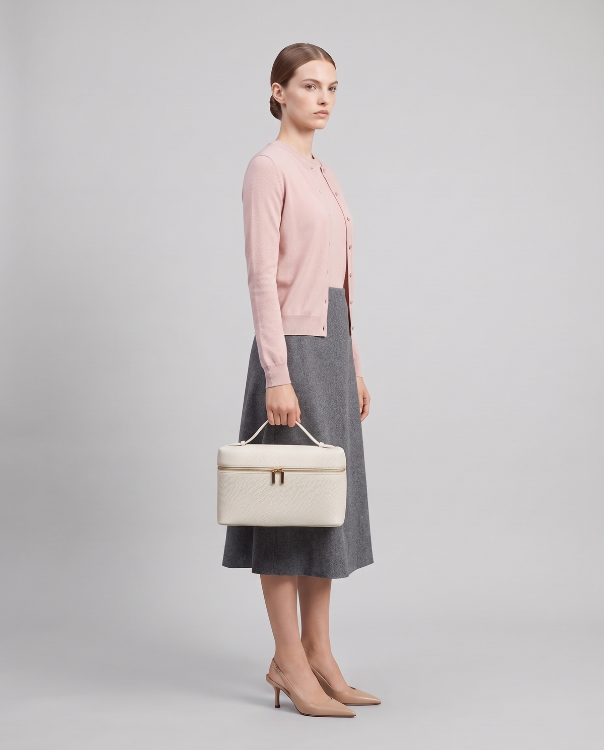 Model carrying the Orvieto vanity case in Ivory