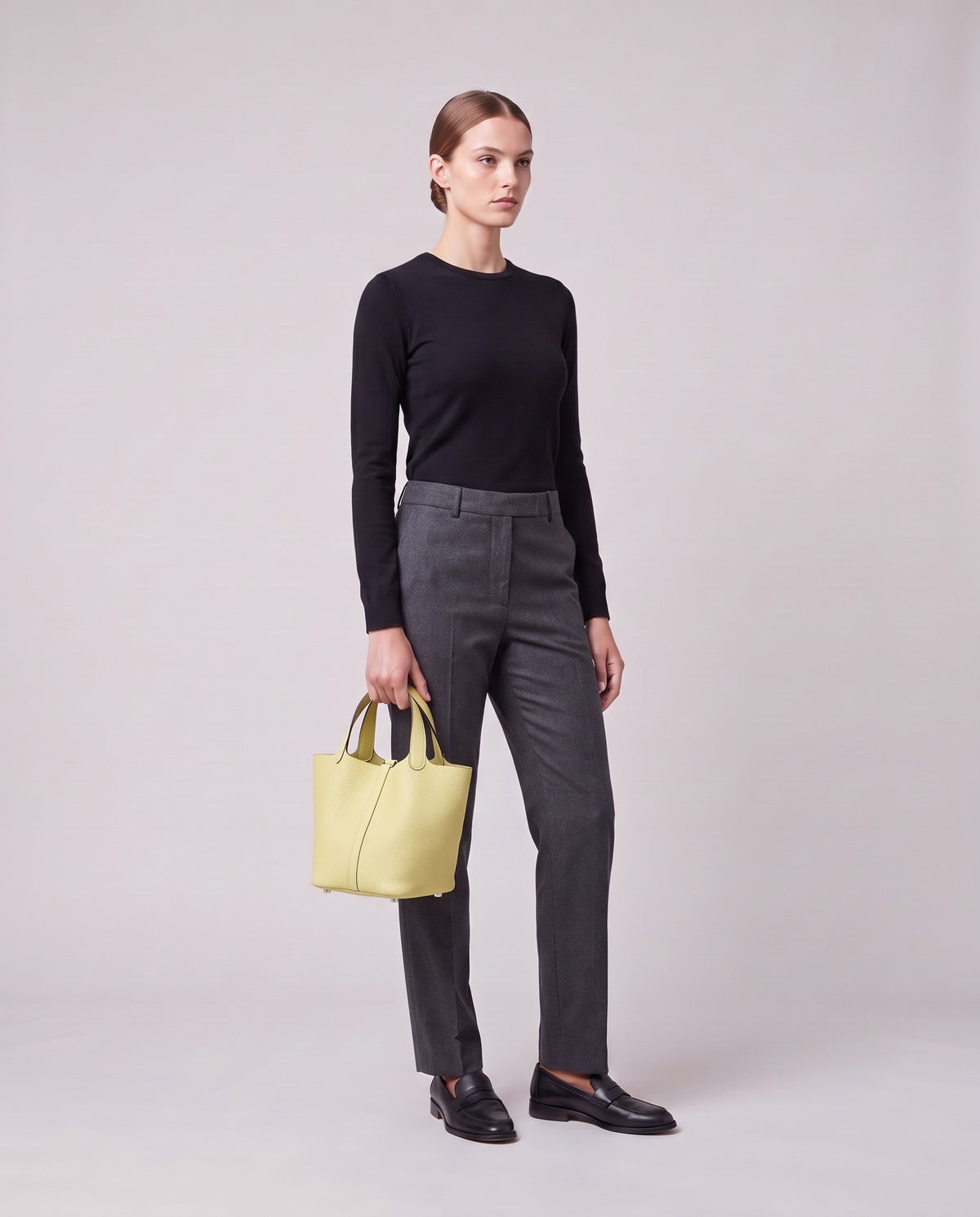 Model holding the Valentina Ostuni Small bag in Butter, full length