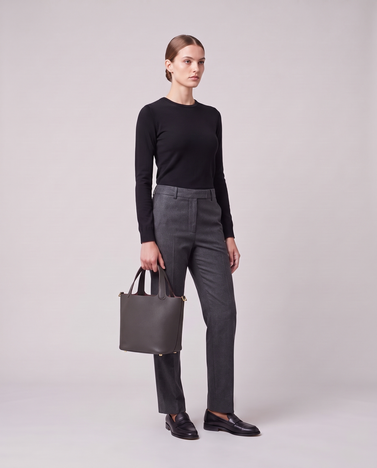 Model holding the Valentina Ostuni Small bag in Charcoal, full length