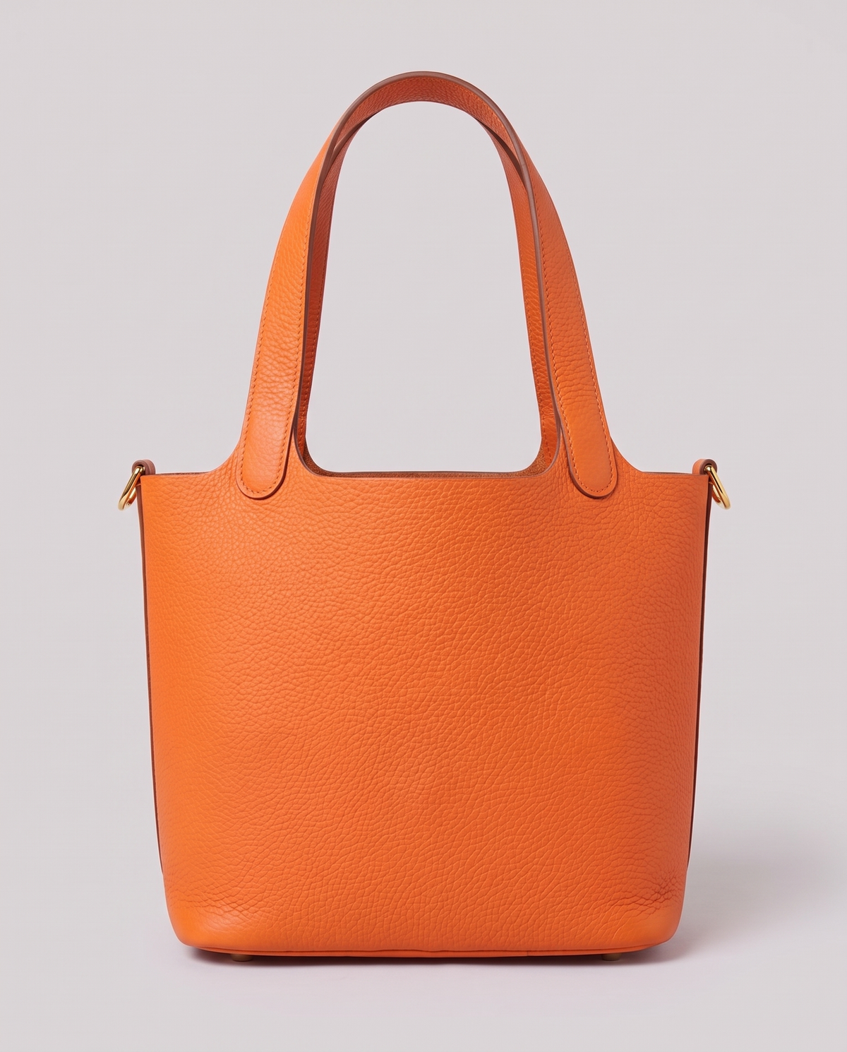Hardware and handle detail on the Valentina Ostuni Small bag in Orange