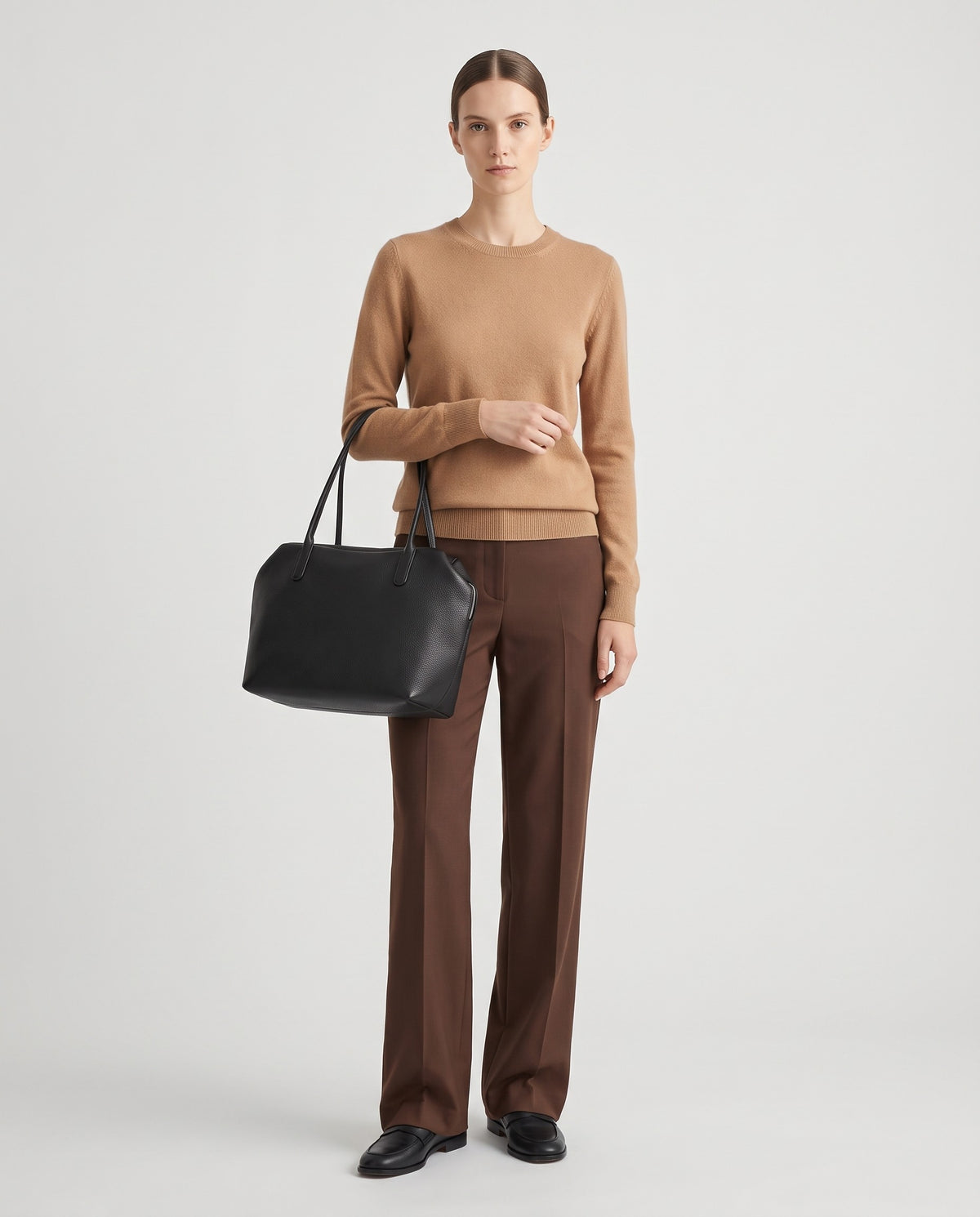 Pavia leather tote in Black – model holding it, full length