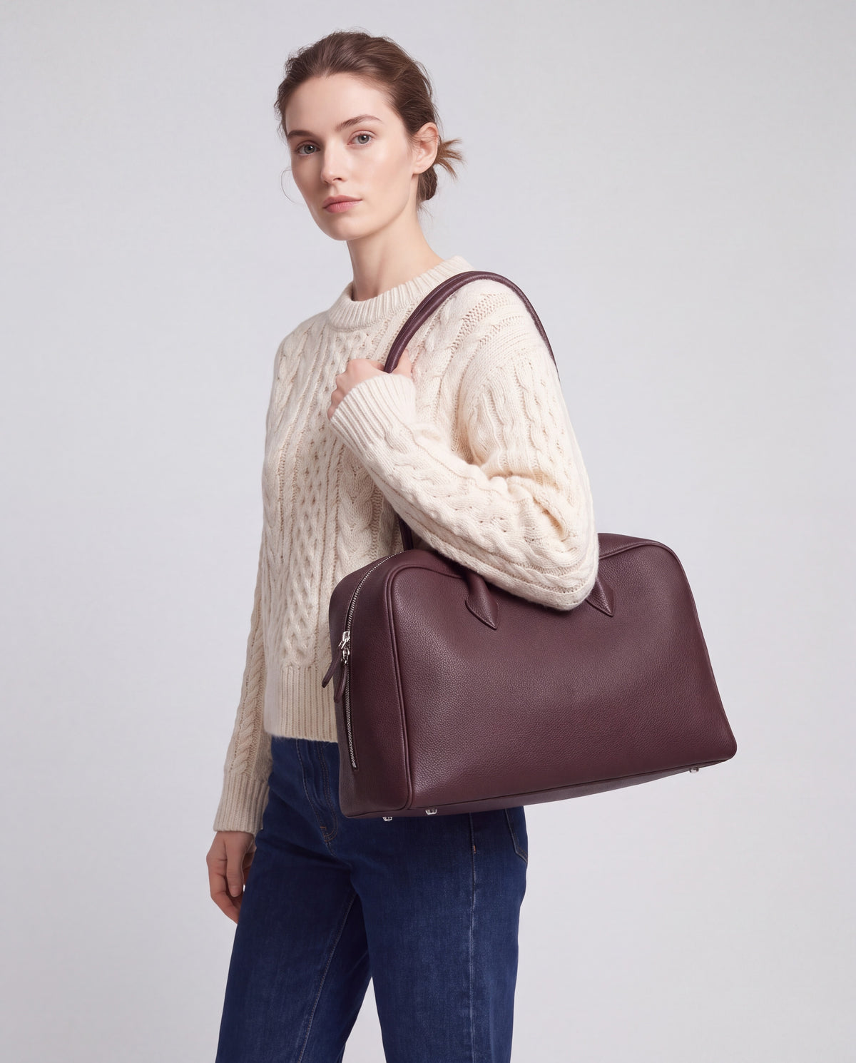 Pillow bag in Chocolate – carried by model, close-up