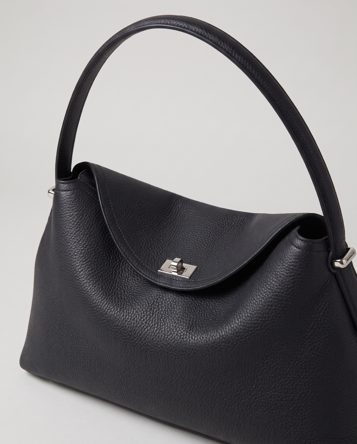 Porto pebbled leather top-handle bag in black, hardware and leather detail