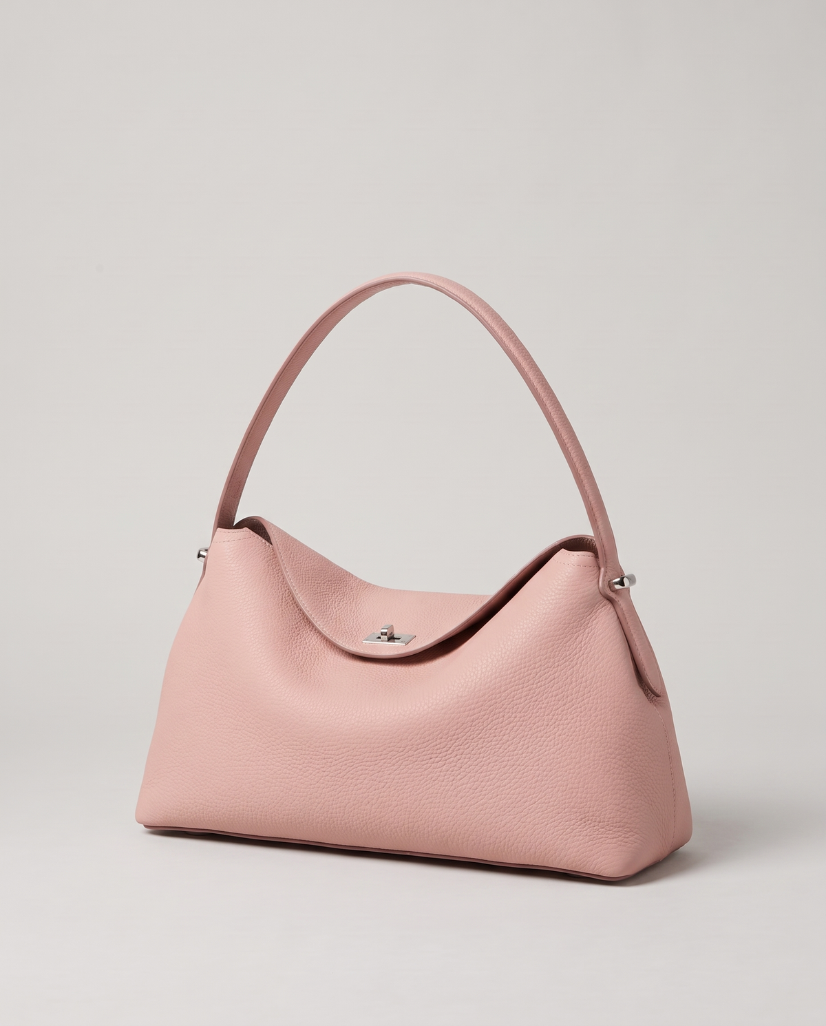 Porto pebbled leather top-handle bag in blush, three-quarter view