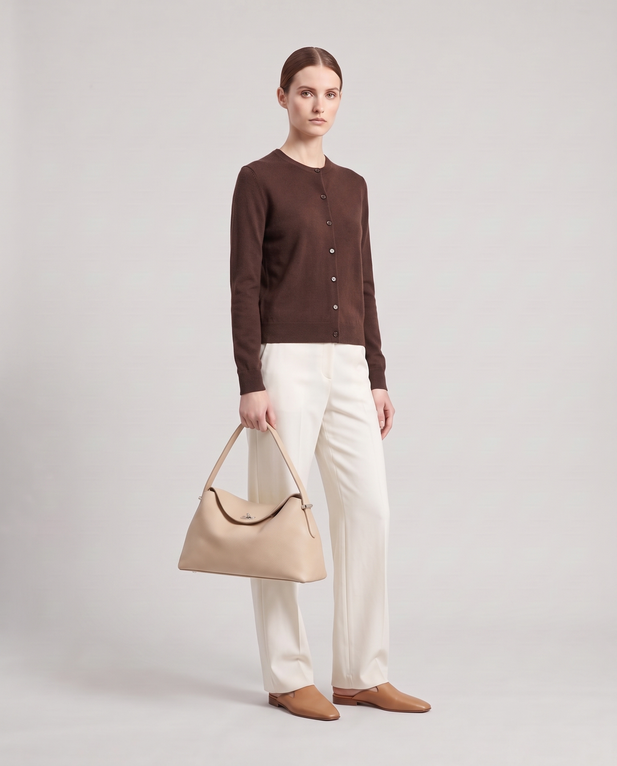 Model holding the Porto top-handle bag in beige, full length