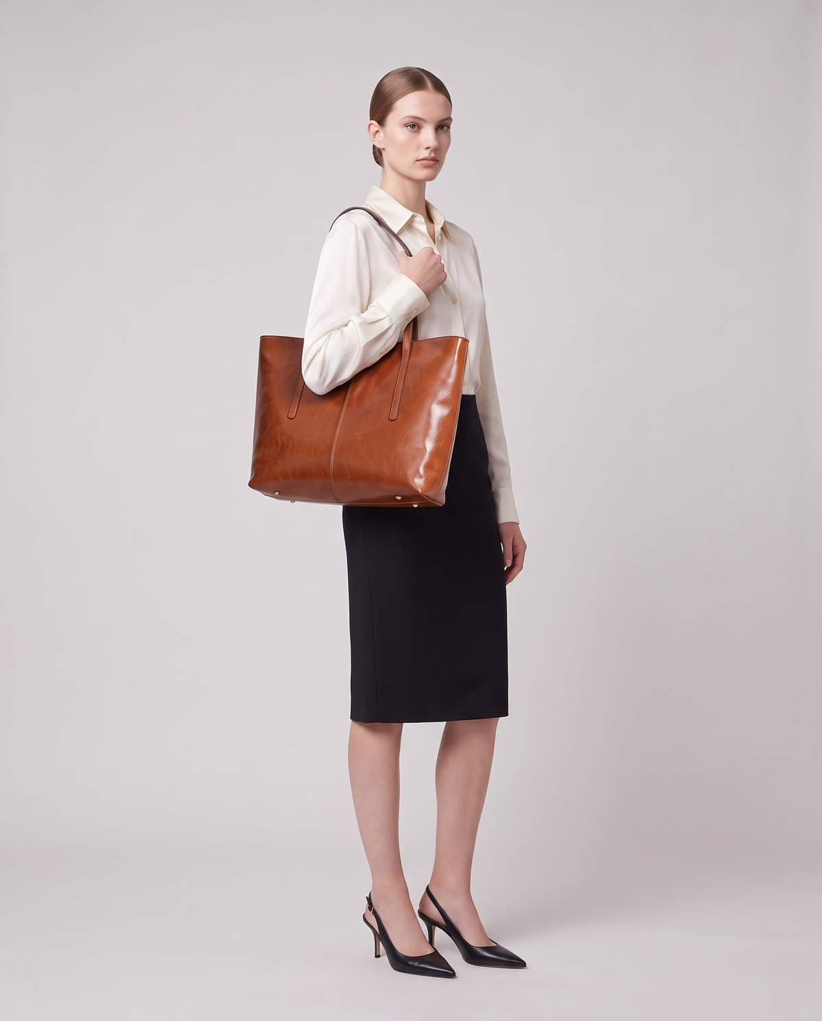 Model holding the Porto top-handle bag in taupe, full length
