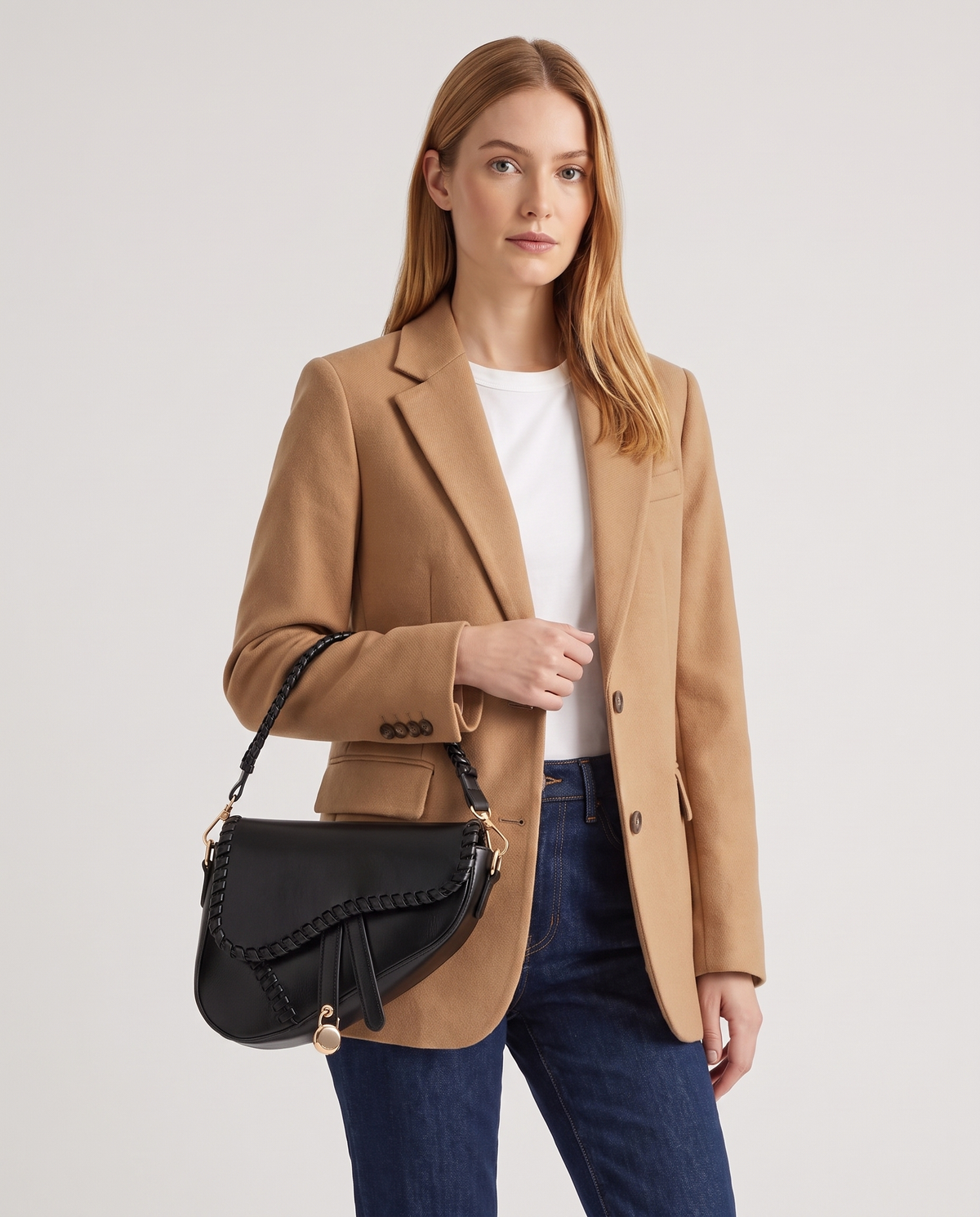 Saddle vegan leather shoulder bag in Black – model wearing it on the shoulder, waist-up