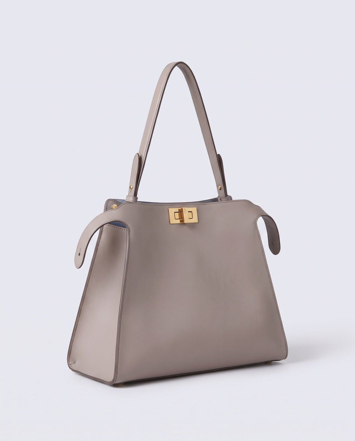 Siracusa structured leather top-handle bag in Stone – three-quarter view
