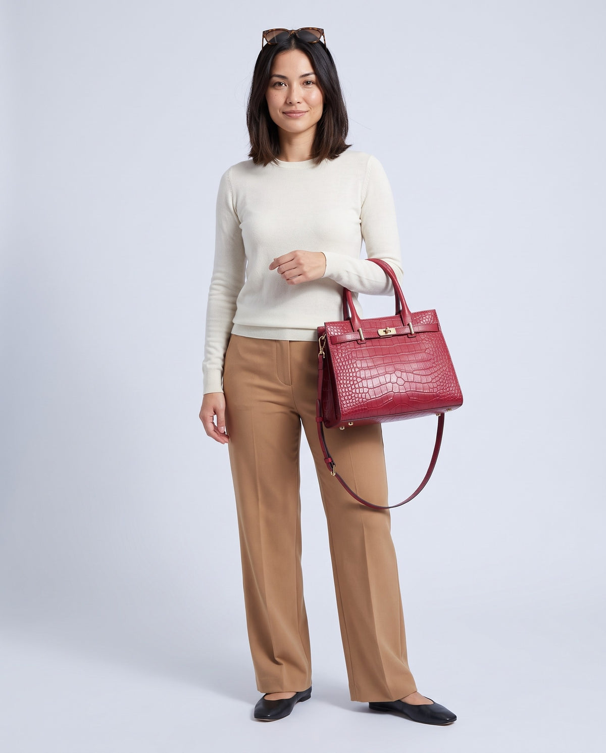 Model wearing the Sorrento croc-embossed top-handle bag in Cherry – full-length view