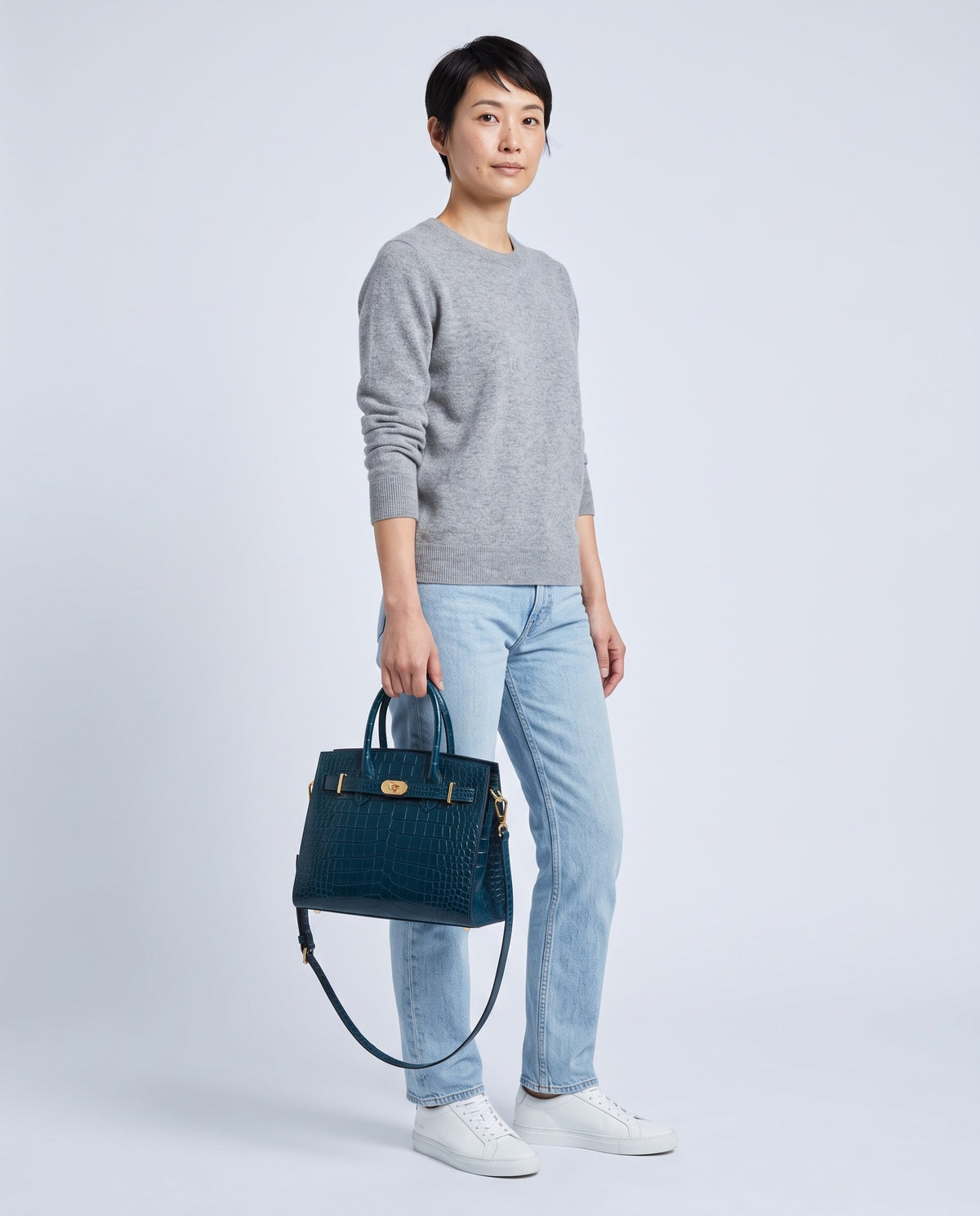 Model wearing the Sorrento croc-embossed top-handle bag in Navy – full-length view