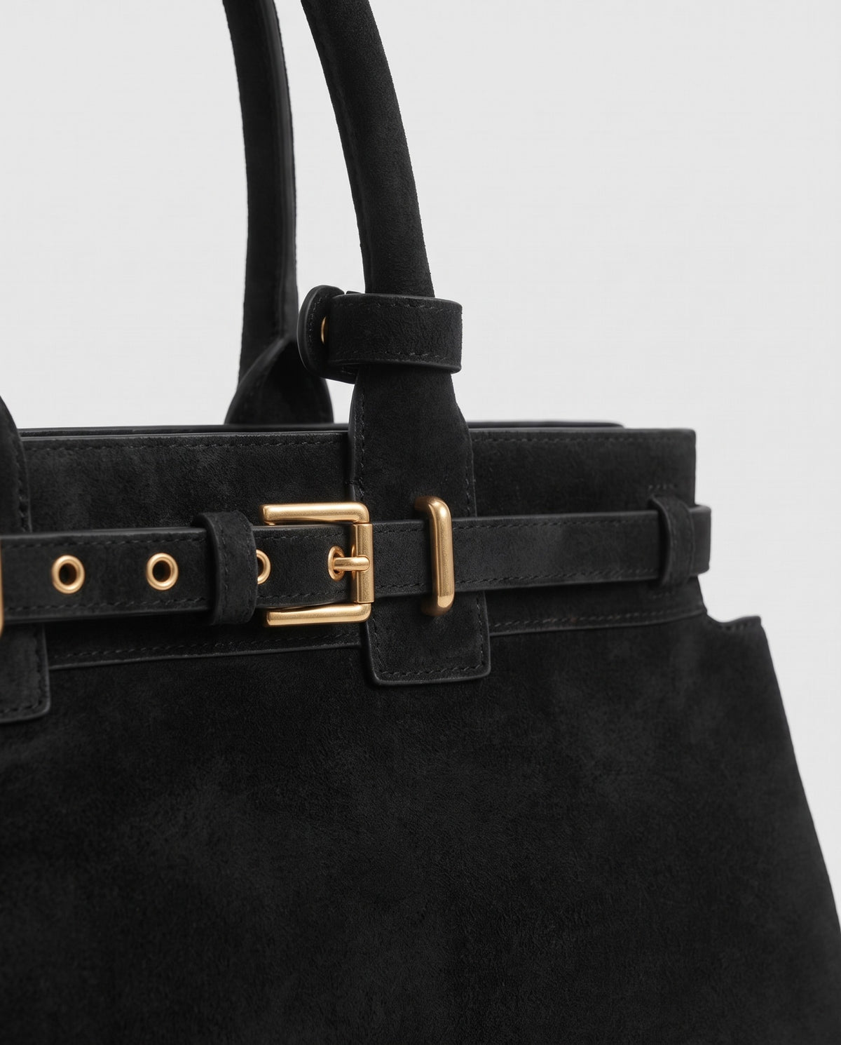 Gold buckle detail on the Spello top-handle bag in Black
