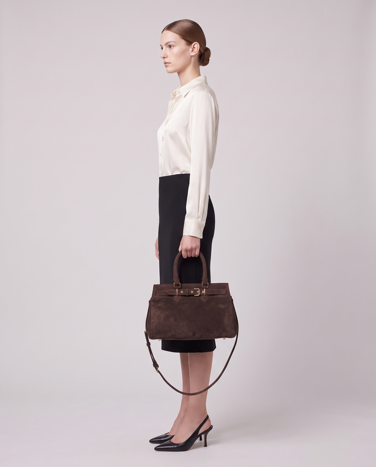 Model carrying the Spello top-handle bag in Chocolate