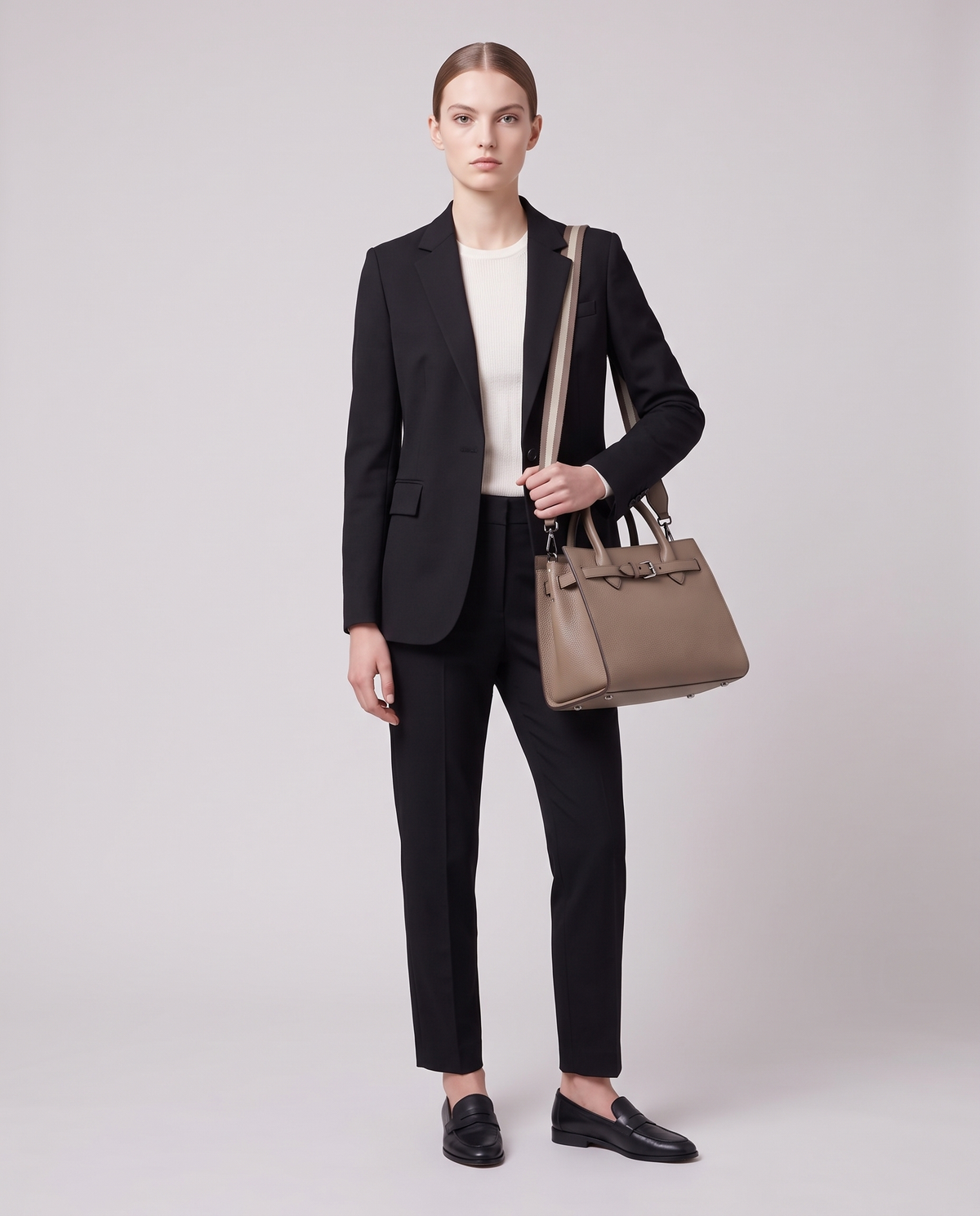 Model carrying the Taormina leather bag in Taupe – full length