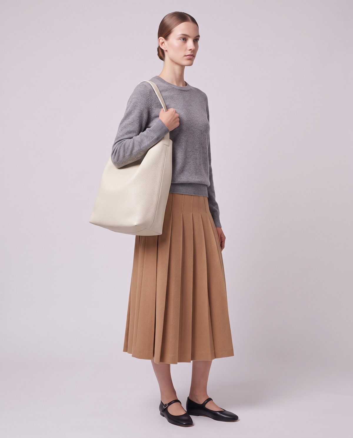Model carrying the Valentina Tela Small bag in Cream