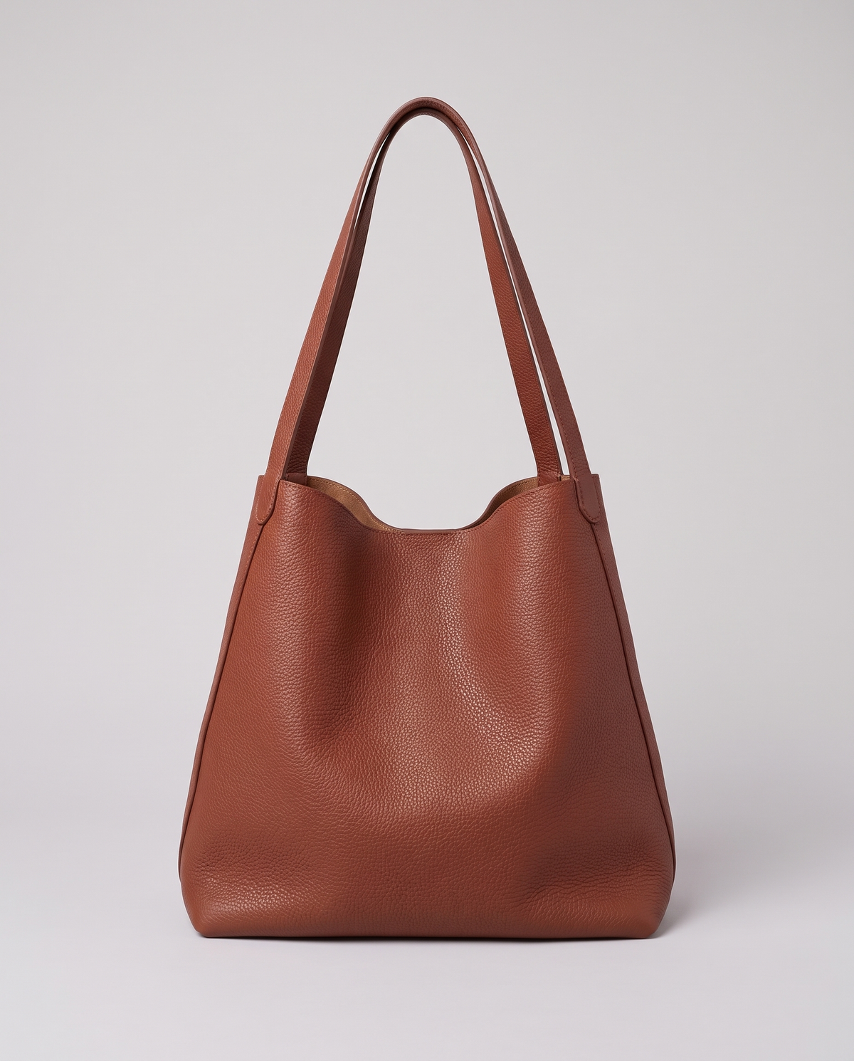 Hardware and handle detail on the Valentina Tela Small bag in Rust
