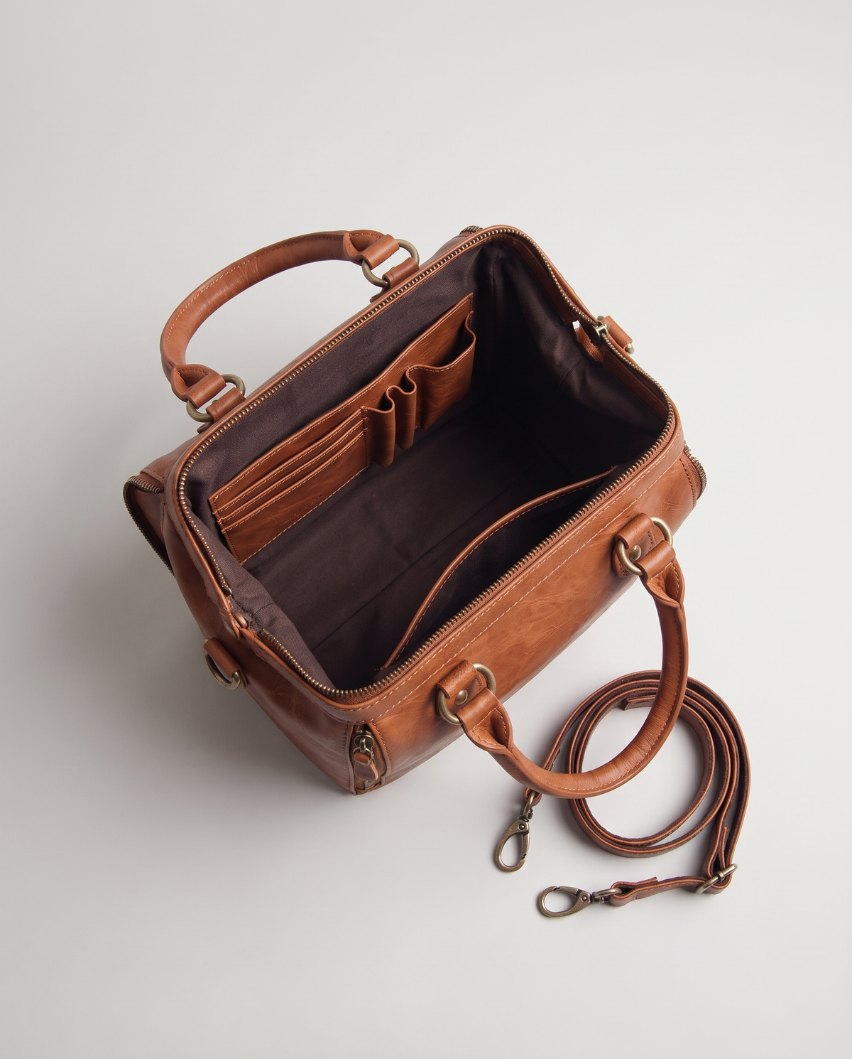 Terra leather satchel in Brown – opened wide, showing the organised interior